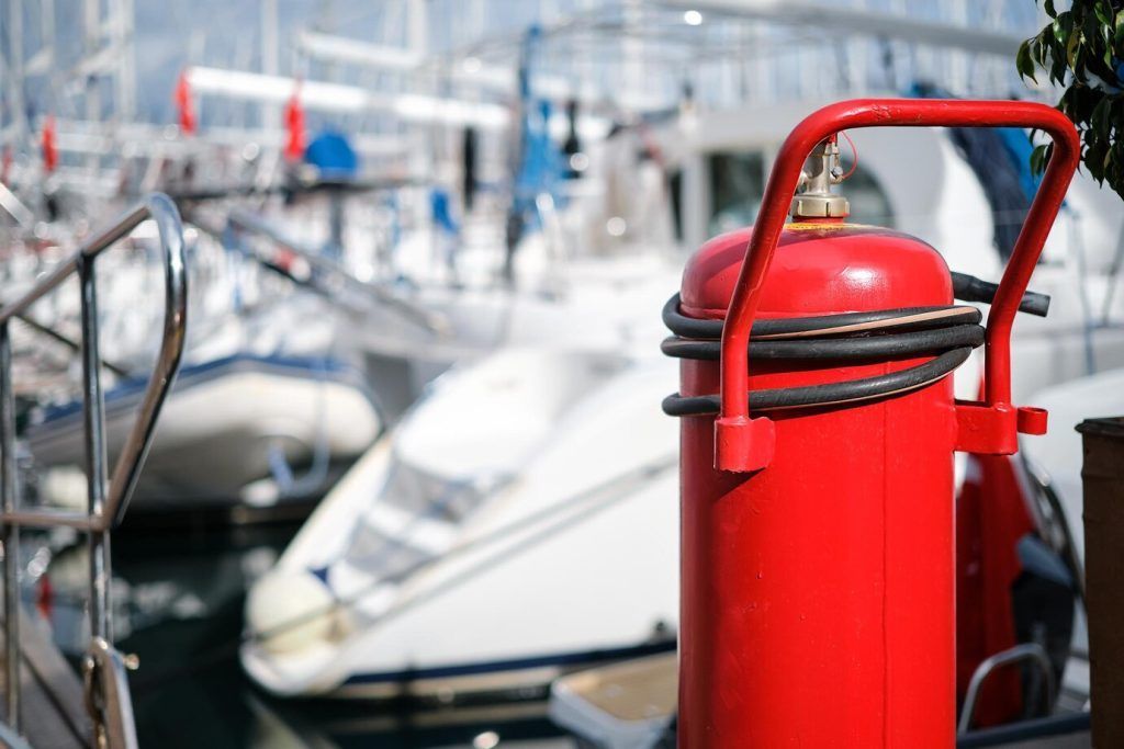 fire-extinguisher-closeup-mooring-yacht-club-blurred-background-providing-fire-protection-safety-prevention_166373-3235
